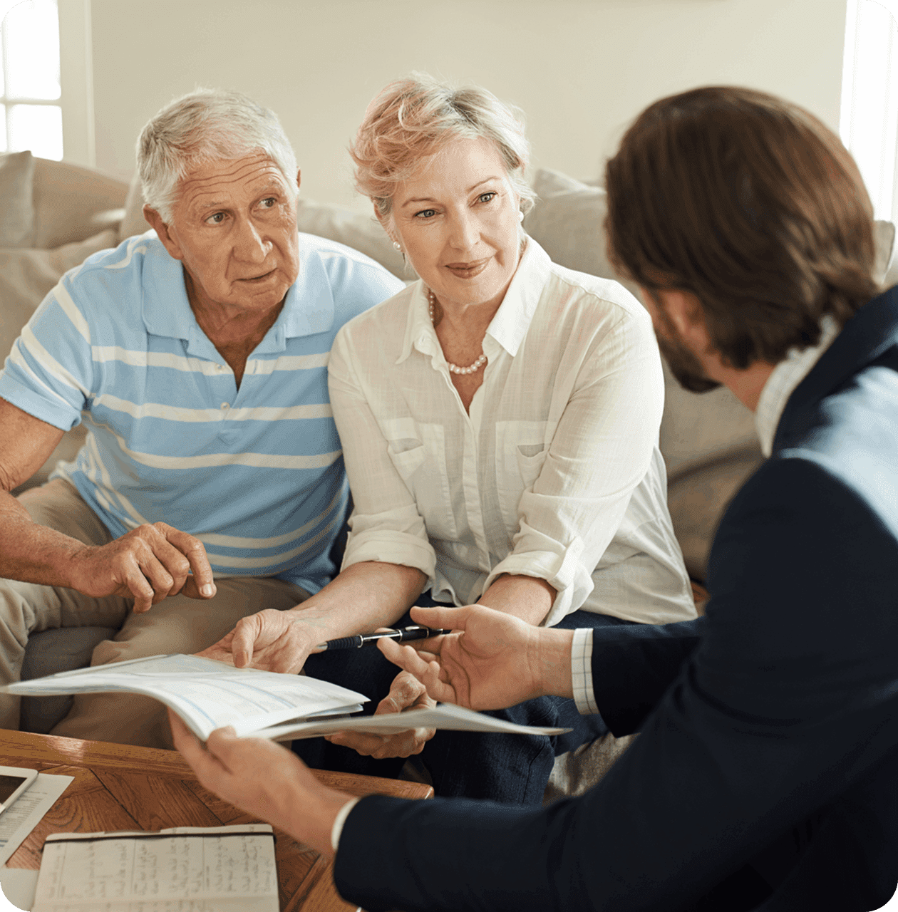 Older couple discussing documents with advisor.